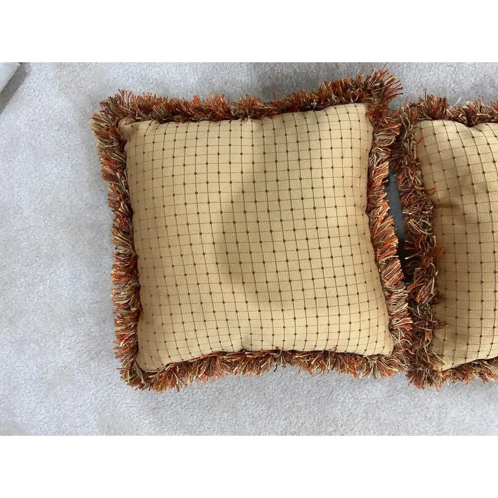 Pair of grid or checkpattern throw pillows orange brown gold